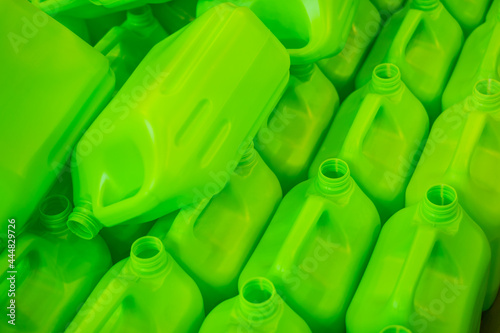 Many empty green plastic jerrycans background in warehouse, market, factory or exhibition photo