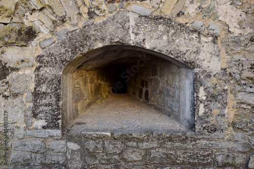 An embrasure for shooting in the thick wall of an old fortress or castle
