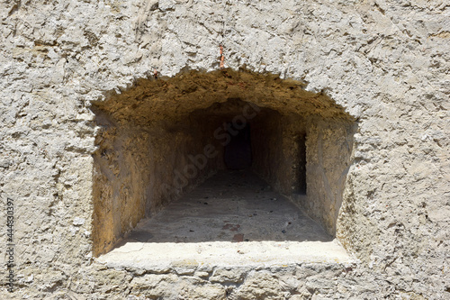 An embrasure for shooting in the thick wall of an old fortress or castle