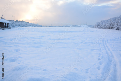 MURMANSK, RUSSIA - FEBRUARY 10, 2021: Semonovskoye lake covered by snow in winter © Andrey