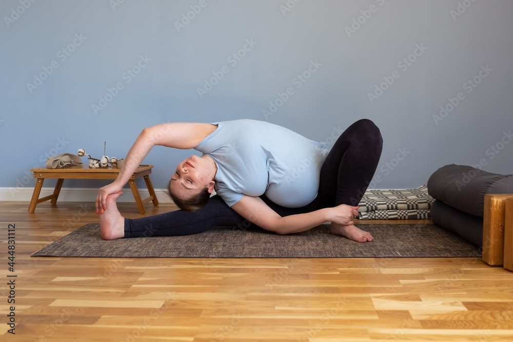 Pregnant caucasian woman sitting in yoga asana Pregnant caucasian woman sitting in yoga asana