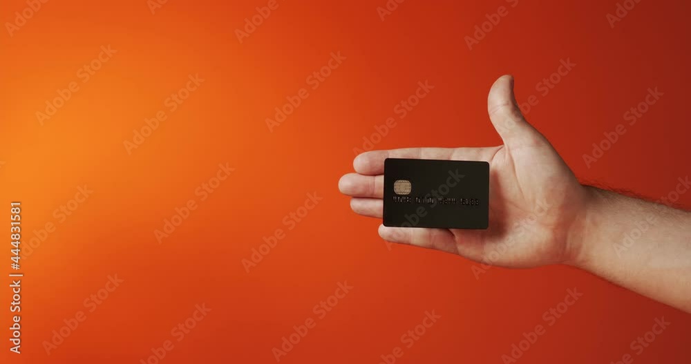 Close up male hand showing levitating template mockup Bank credit card with online service isolated on orange background Close up male hand showing levitating template mockup Bank credit card with online service isolated on orange background