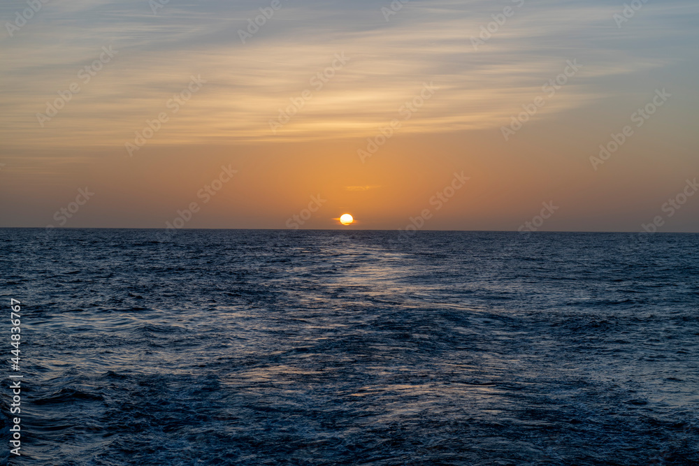 Beautiful seascape - waves and sky with clouds with beautiful lighting. Golden hour. Sunset at sea.