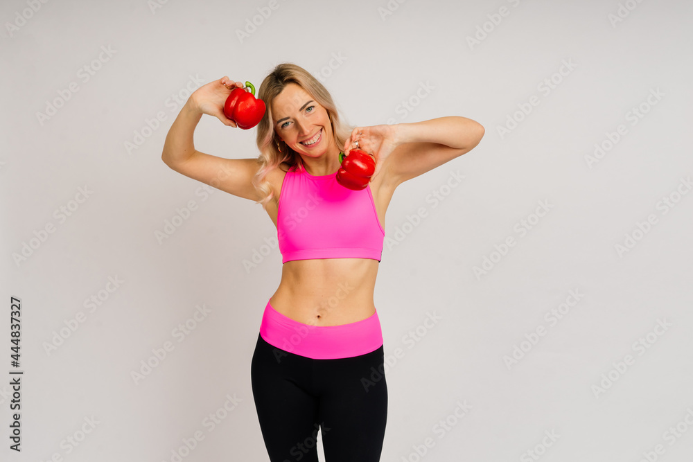 Studio shot of young fitness woman in sports clothing holding green apple, fruits, vegetables. Studio shot of young fitness woman in sports clothing holding green apple, fruits, vegetables.