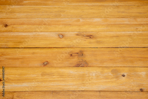 Nice table top made of horizontal wooden planks varnished with worn yellow tones. Vector wood texture.
