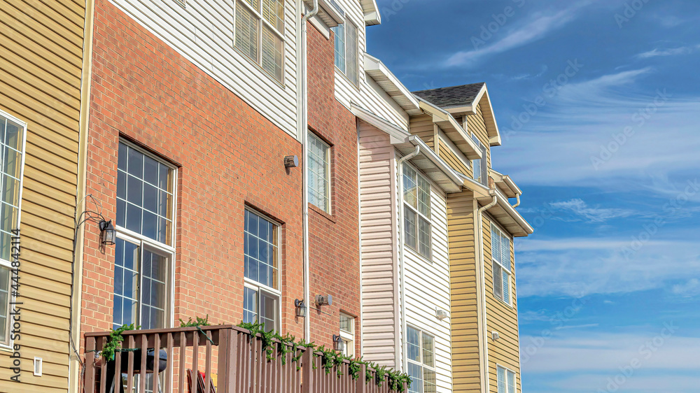 Obraz premium Pano Townhouses with balconies that looks out to scenic views of the neighborhood