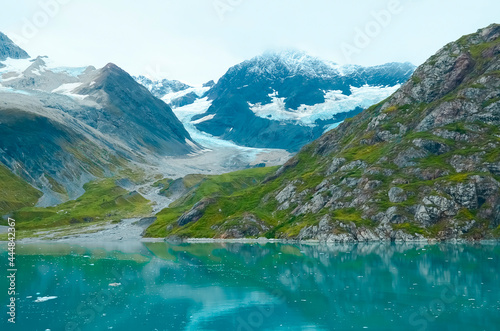 Alaska landscape mountains and water, sunny day, turquoise watercolor. Mountains reflection in the water. Remote location, unplugged. Wild beauty in nature. Untouched environment