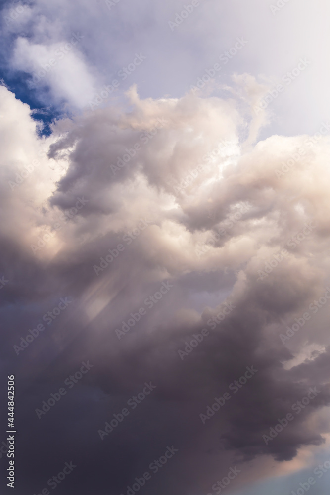 Heaven. Epic Dramatic storm grey white cumulus clouds in sunlight abstract background texture
