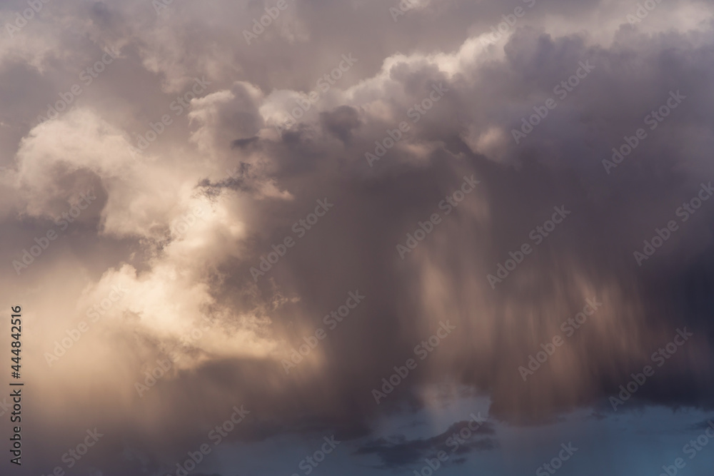 Epic Dramatic storm dark grey white cumulus clouds with rain in sunlight abstract background texture, thunderstorm