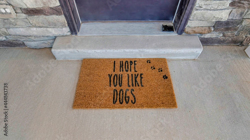 Pano I hope you like dogs doormat at the doorstep of home with gray front door photo