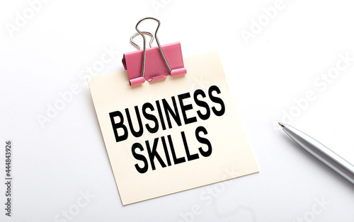 BUSINESS SKILLS text on sticker with pen on the white background