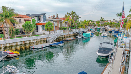 Pano Homes lining the canal with boats in charming Long Beach California neighborhood