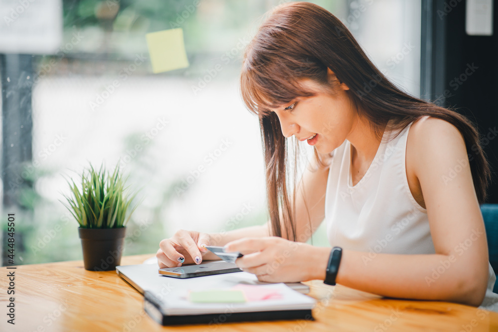 Portrait of asian young beautiful woman using credit card and smartphone laptop for buying online shopping. Portrait of asian young beautiful woman using credit card and smartphone laptop for buying online shopping.