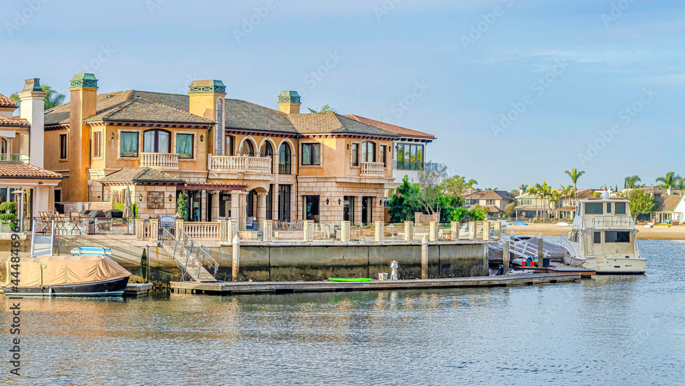 Pano Boats and private yachts of houses overlooking the sea in Huntington Beach CA