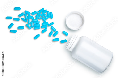 Pills, tablets, drugs, vitamins. White bottle with pill in capsule. Concept medicine for pharmacy, hospital, doctor's office, disease, illness, sick people. Dose of blue tablets. Doctor prescription.