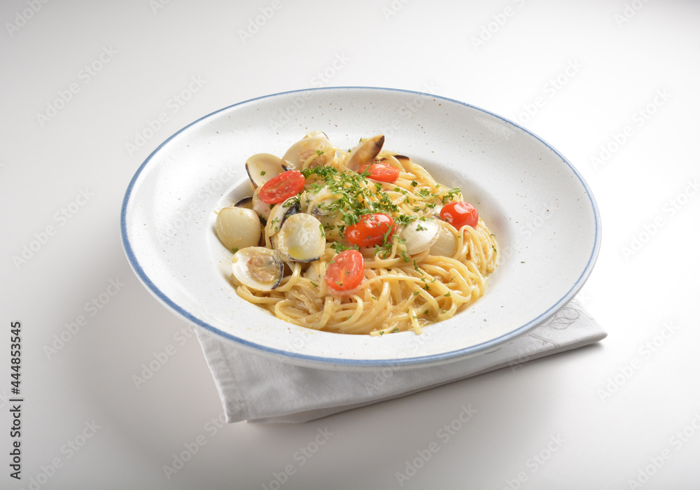 olive oil mixed seafood clam shell pasta in aglio olio style and cherry