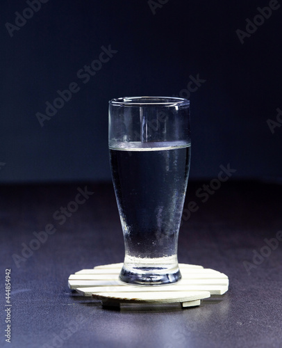 glass of mineral water isolated on wooden plate