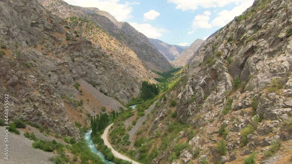 Aerial View Of Jade Lake On Foothills Of Rocky Slopes At Mountain Urungach In Ugam-Chatkal National Park, Uzbekistan. - Drone Shot Aerial View Of Jade Lake On Foothills Of Rocky Slopes At Mountain Urungach In Ugam-Chatkal National Park, Uzbekistan. - Drone Shot