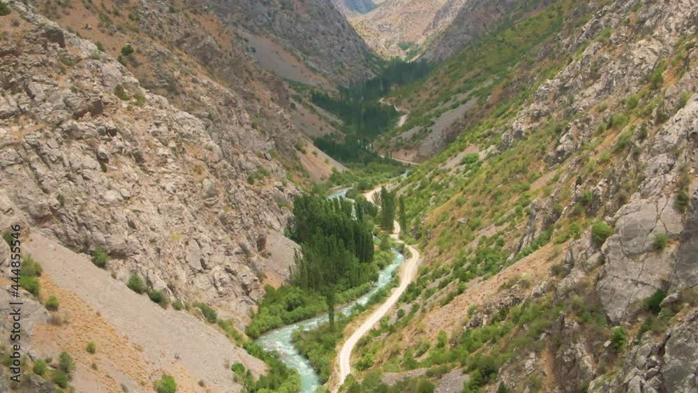 Wavelike Shape Of Pskem River At The Valley Of Rocky Mountains In Ugam-Chatcal National Park In Uzbekistan. aerial Wavelike Shape Of Pskem River At The Valley Of Rocky Mountains In Ugam-Chatcal National Park In Uzbekistan. aerial