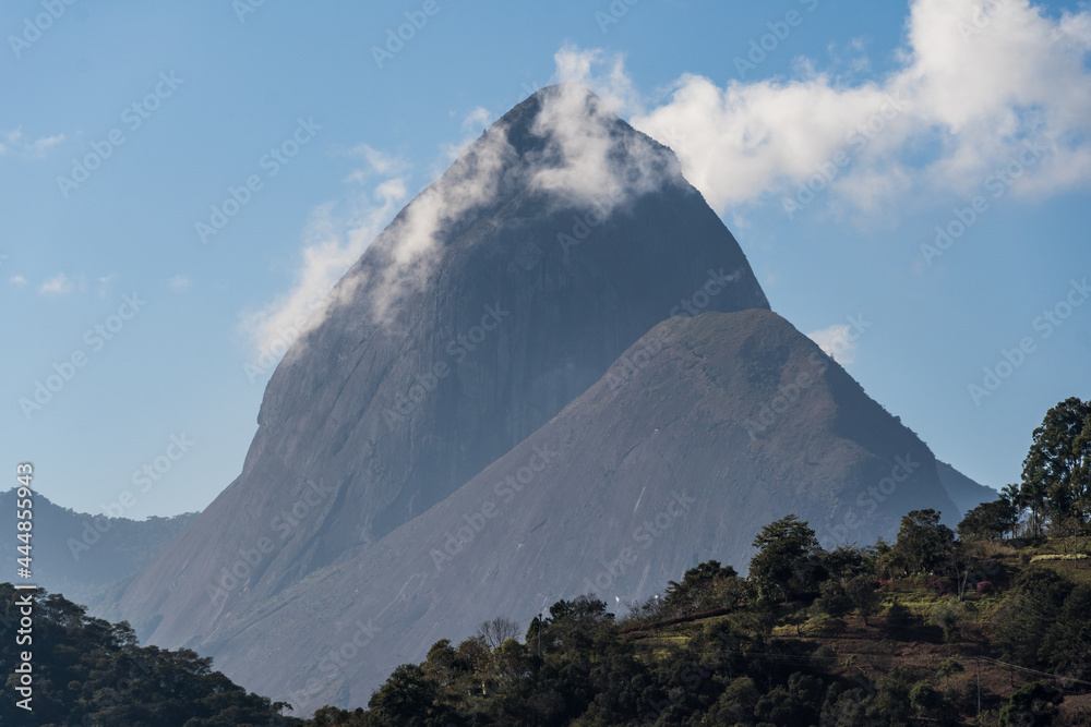Sunny day with some clouds in the mountains and hills in Itaipava, Petrópolis. Mountain region of Rio de Janeiro, Brazil. Aerial view. Selective focus. Sunny day with some clouds in the mountains and hills in Itaipava, Petrópolis. Mountain region of Rio de Janeiro, Brazil. Aerial view. Selective focus.