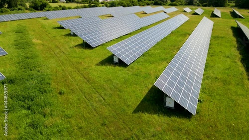 Solar Panels On Farm - Aerial View Of Solar Panels Absorbing Sunligtht Into Electricity. photo