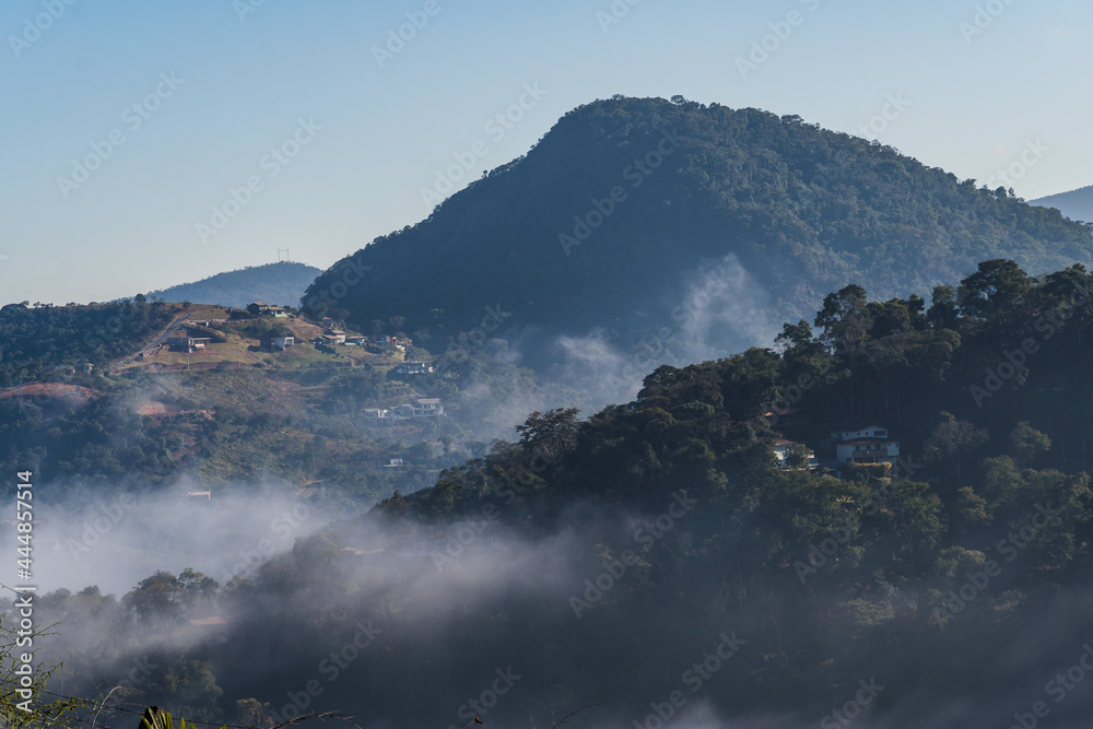 Dawn with a lot of fog in the mountains and hills in Itaipava, Petrópolis. Mountain region of Rio de Janeiro, Brazil. Aerial view. Selective focus.