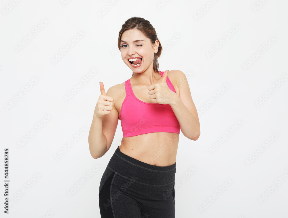 portrait of a smiling fitness woman in headphones working out isolated over white background portrait of a smiling fitness woman in headphones working out isolated over white background