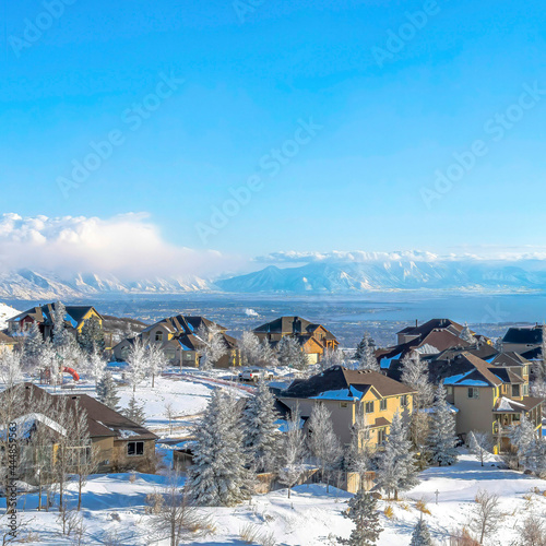 Square Panorama of snowy mountain town and valley on a scenic sunny winter setting