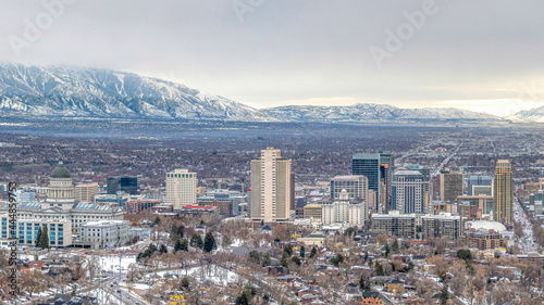 Pano Panorama of Salt Lake City with snowy mountain and gray cloudy sky in winter