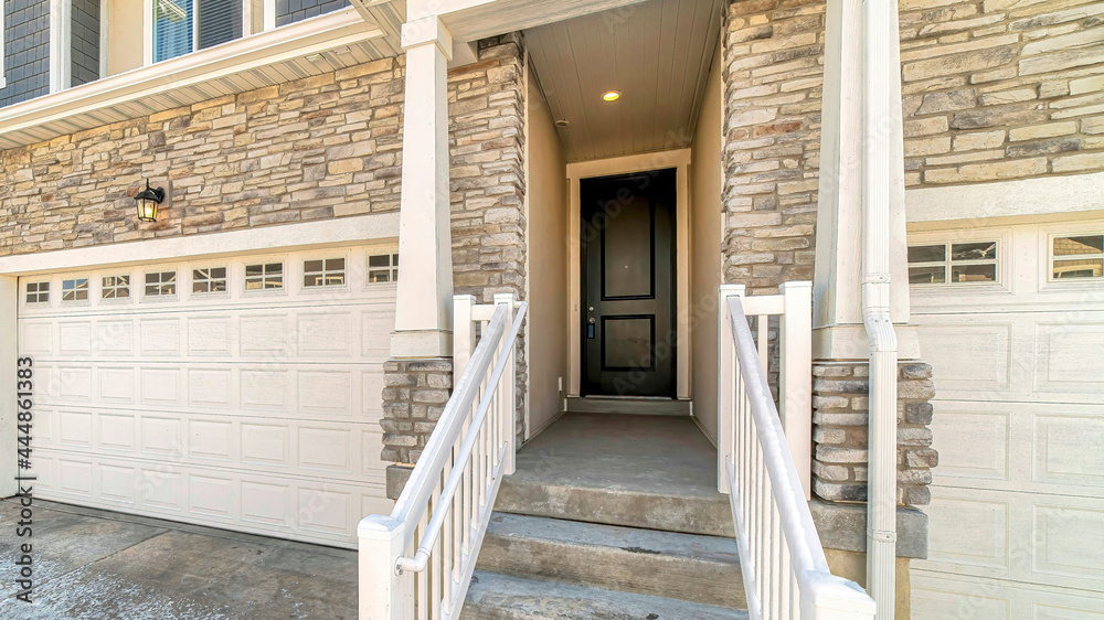Pano Townhouse entrance with concrete stairs leading to front door under a portico