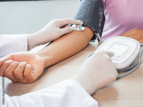 Blood pressure measurement. A Doctor using pressure gauge examining at a patient arm. Health insurance, healthcare concept. Healthy lifestyle people. Comfortable and service in a hospital.