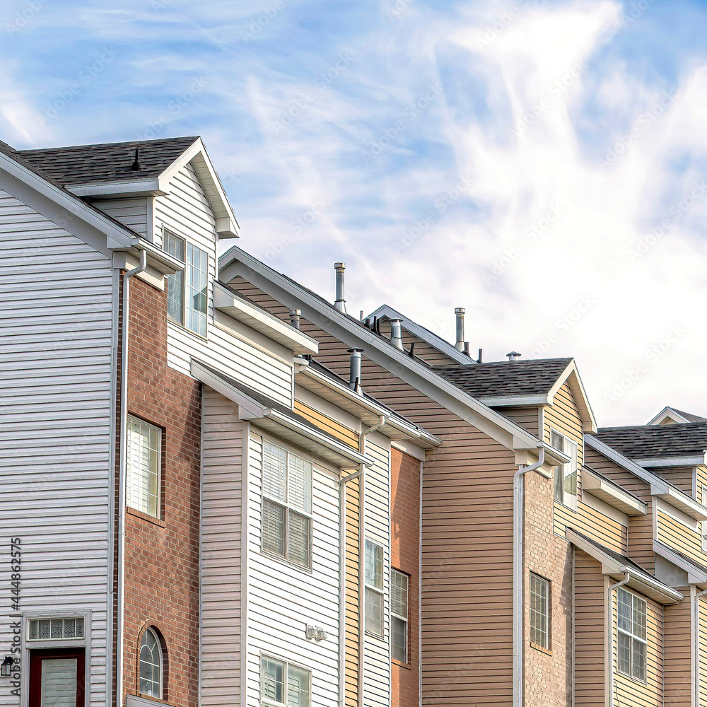 Square Townhouses facade on a picturesque neighborhood with Wasatch Mountain peak view Square Townhouses facade on a picturesque neighborhood with Wasatch Mountain peak view