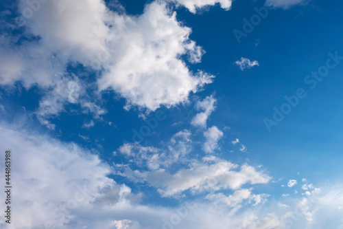 Soft white clouds against blue sky background.