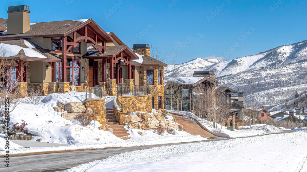 Pano Residential community in Park City with homes and mountain view against blue sky Pano Residential community in Park City with homes and mountain view against blue sky