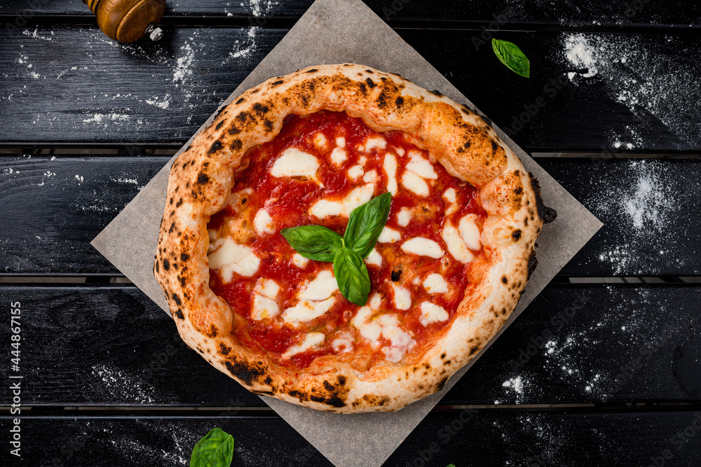 true Italian Pizza. Traditional Pizza Margherita with fresh mozzarella and basil - obrazy, fototapety, plakaty 