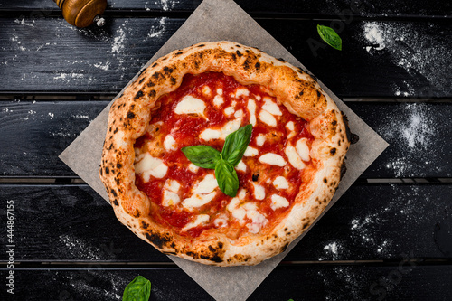 true Italian Pizza. Traditional Pizza Margherita with fresh mozzarella and basil photo