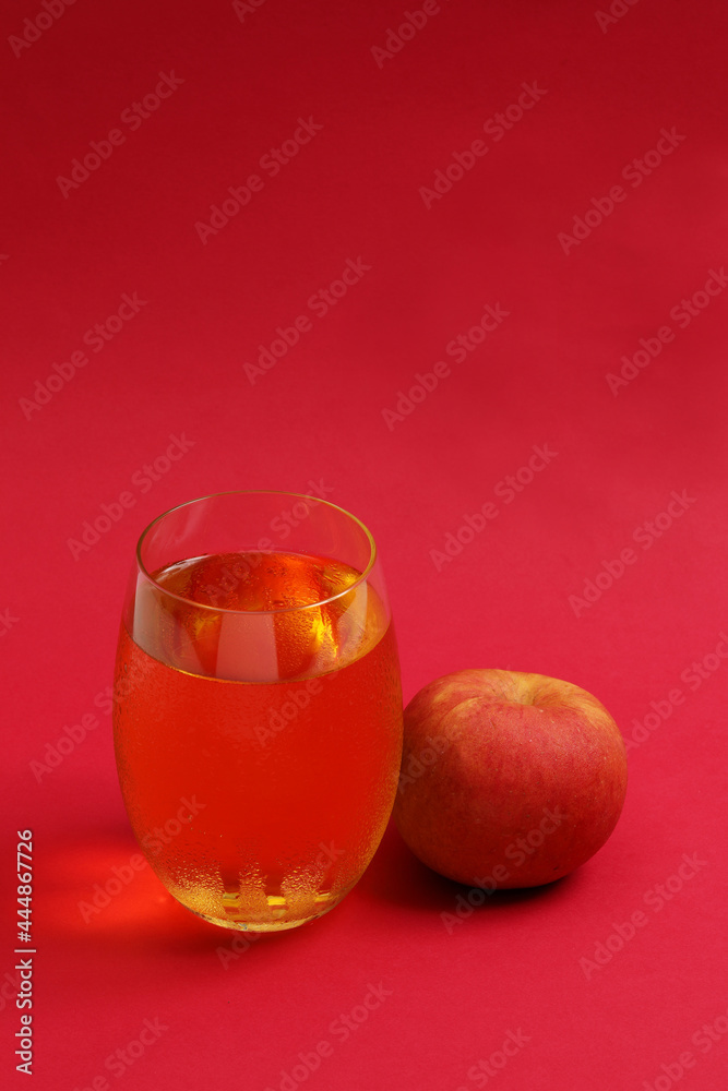A glass of apple juice with fresh apple. A glass of apple juice with fresh apple.