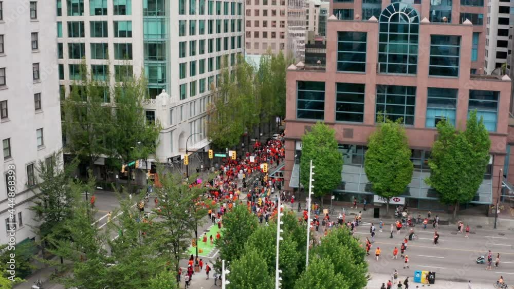 Protesters Walk in a Busy Downtown Urban Area, Drone View from Above in UHD Protesters Walk in a Busy Downtown Urban Area, Drone View from Above in UHD