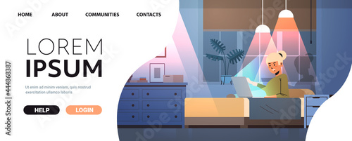 overworked businesswoman freelancer looking at computer screen girl sitting on bed in dark night home room