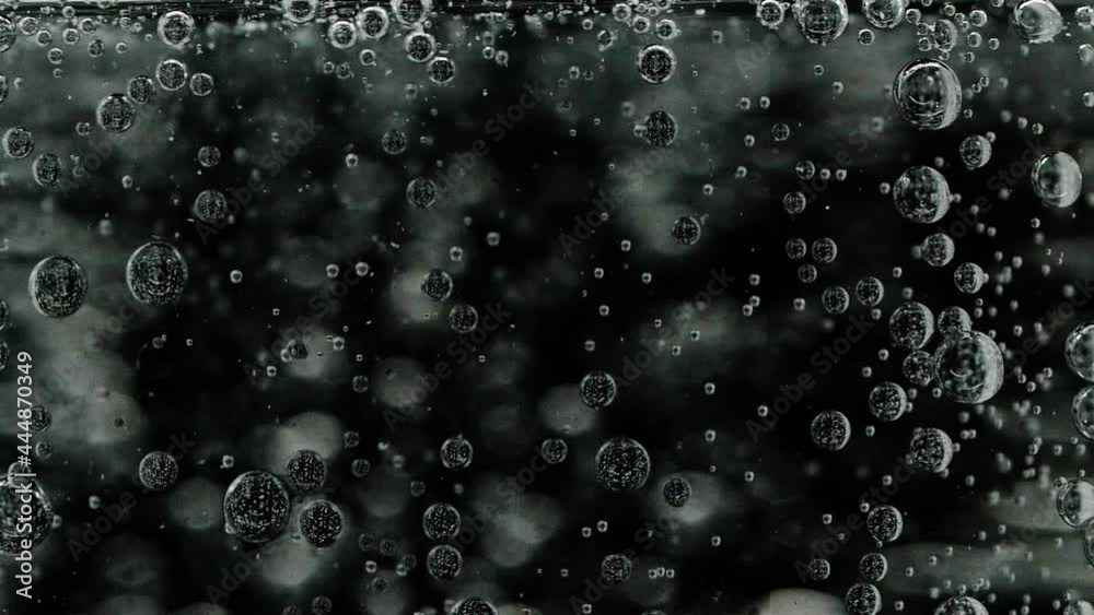 Slow motion closeup abstract water bubbles on black background, macro soda drink Slow motion closeup abstract water bubbles on black background, macro soda drink