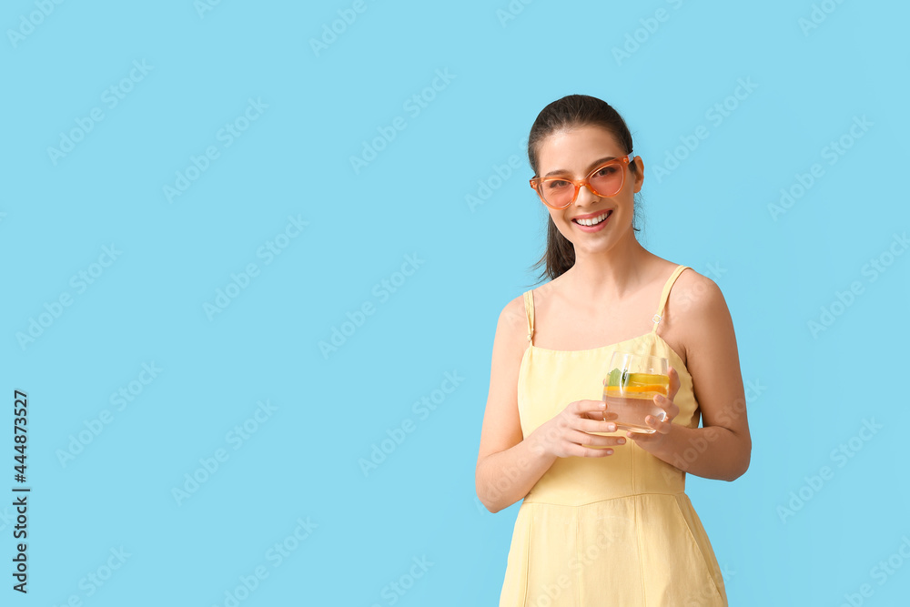 Young woman with fresh lemonade on color background Young woman with fresh lemonade on color background