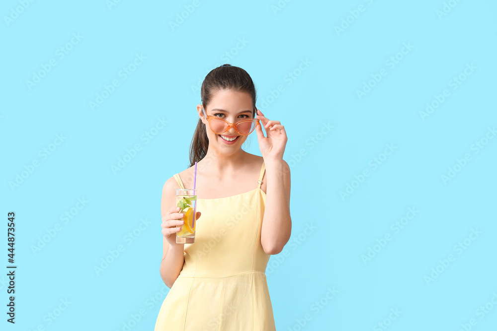 Young woman with fresh lemonade on color background Young woman with fresh lemonade on color background