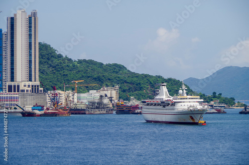 Cruiseship cruise ship liner in port of Hongkong Hong Kong, China with Kai Tak cruise terminal and city skyline photo