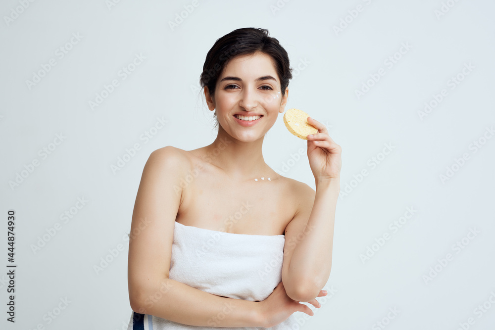 pretty woman with bare shoulders clean skin sponge in hands hygiene pretty woman with bare shoulders clean skin sponge in hands hygiene