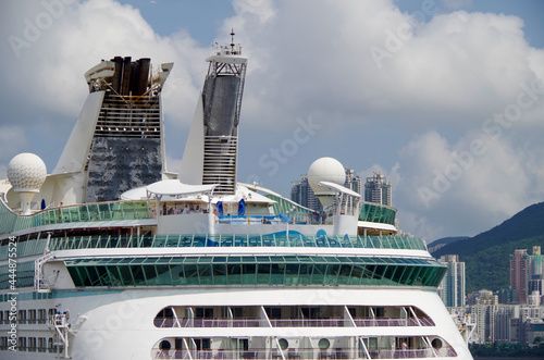 Cruiseship cruise ship liner in port of Hongkong Hong Kong, China with Kai Tak cruise terminal and city skyline photo