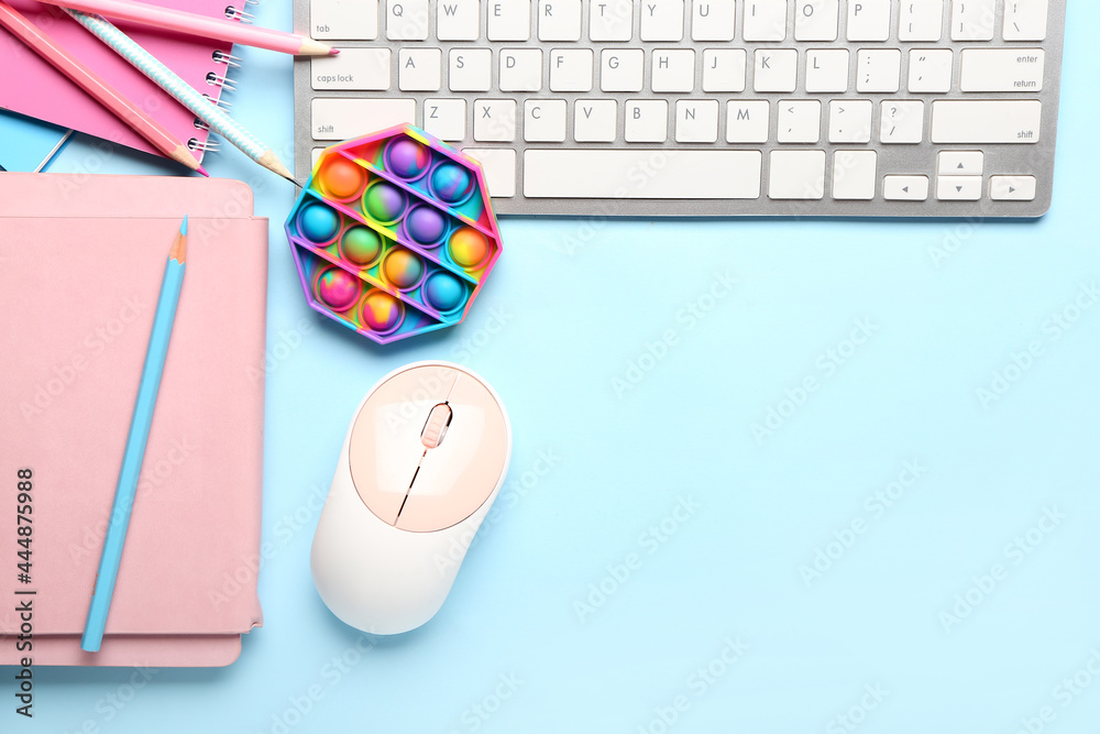 Pop it fidget toy, stationery and PC keyboard on color background Stock ...