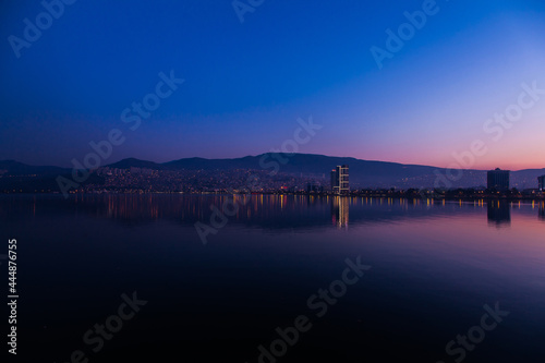 View of the city of Izmir, Turkey. Panorama of Izmir after sunset at golden hour from the sea.