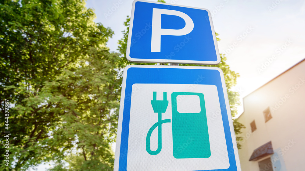 Recharging point for electric vehicles and parking sign against greenery Recharging point for electric vehicles and parking sign against greenery