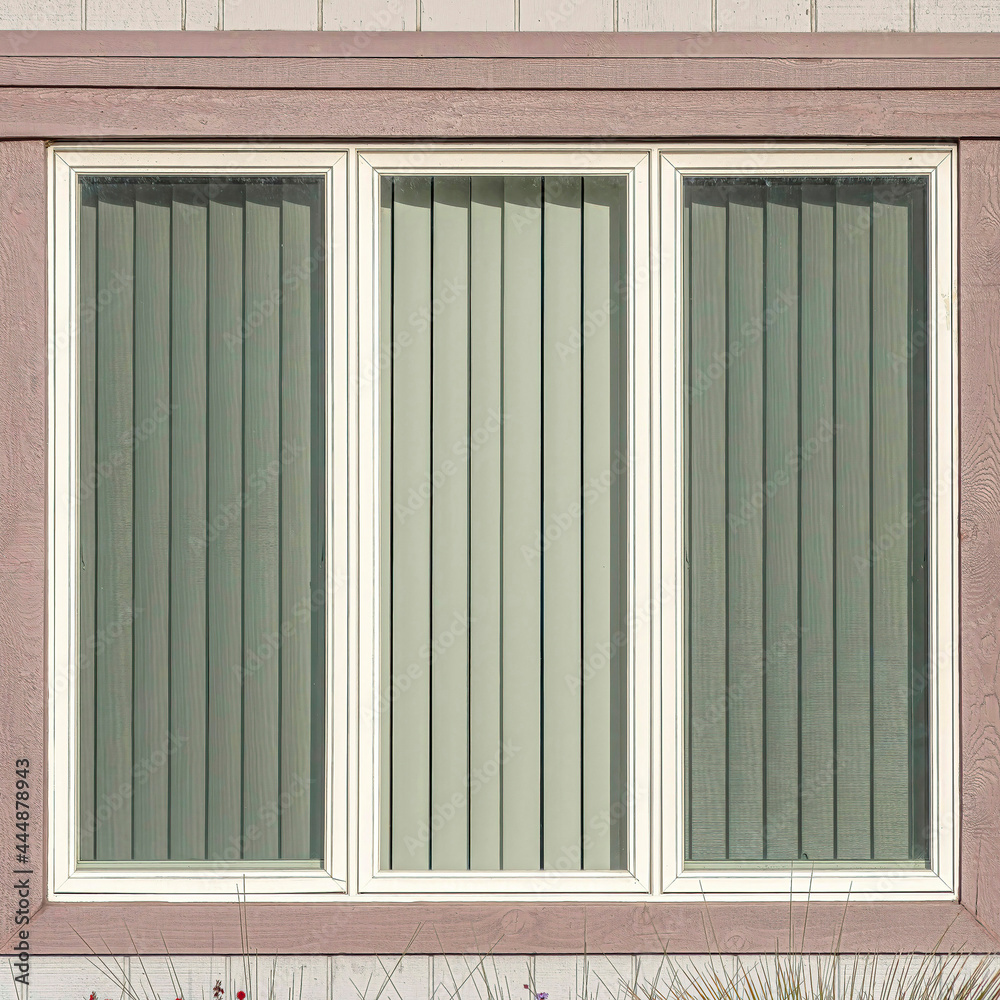 Square Window with three glass panes at house exterior in Huntington Beach California Square Window with three glass panes at house exterior in Huntington Beach California
