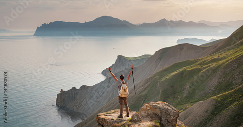Young man travels alone on the backdrop of the mountains